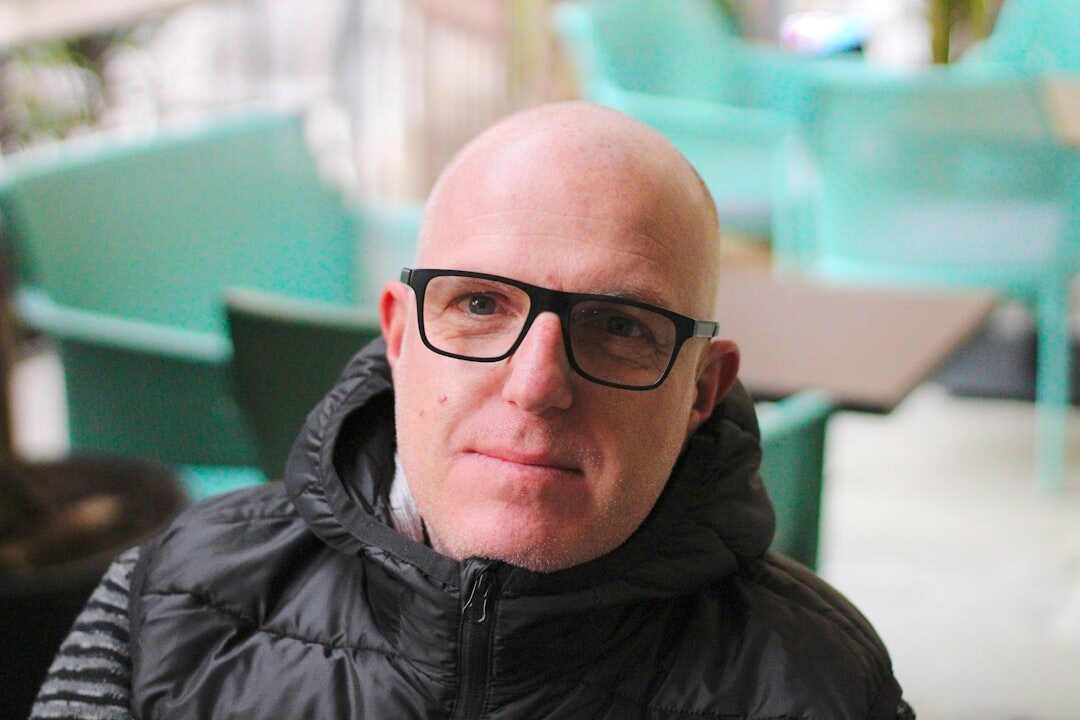 Portrait of a European man editor in his fifties wearing glasses