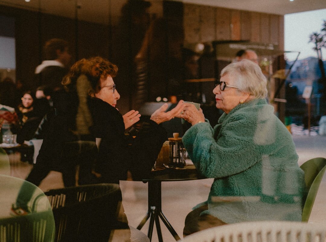 two women talking at event